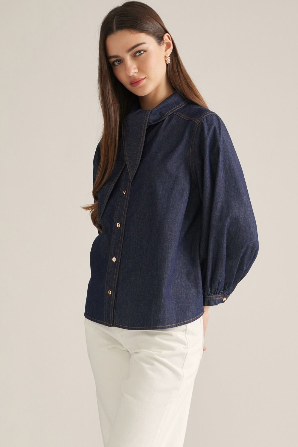 Women's denim-inspired woven top with high neckline, necktie detail, three-quarter puff sleeves, button front, and back pleats