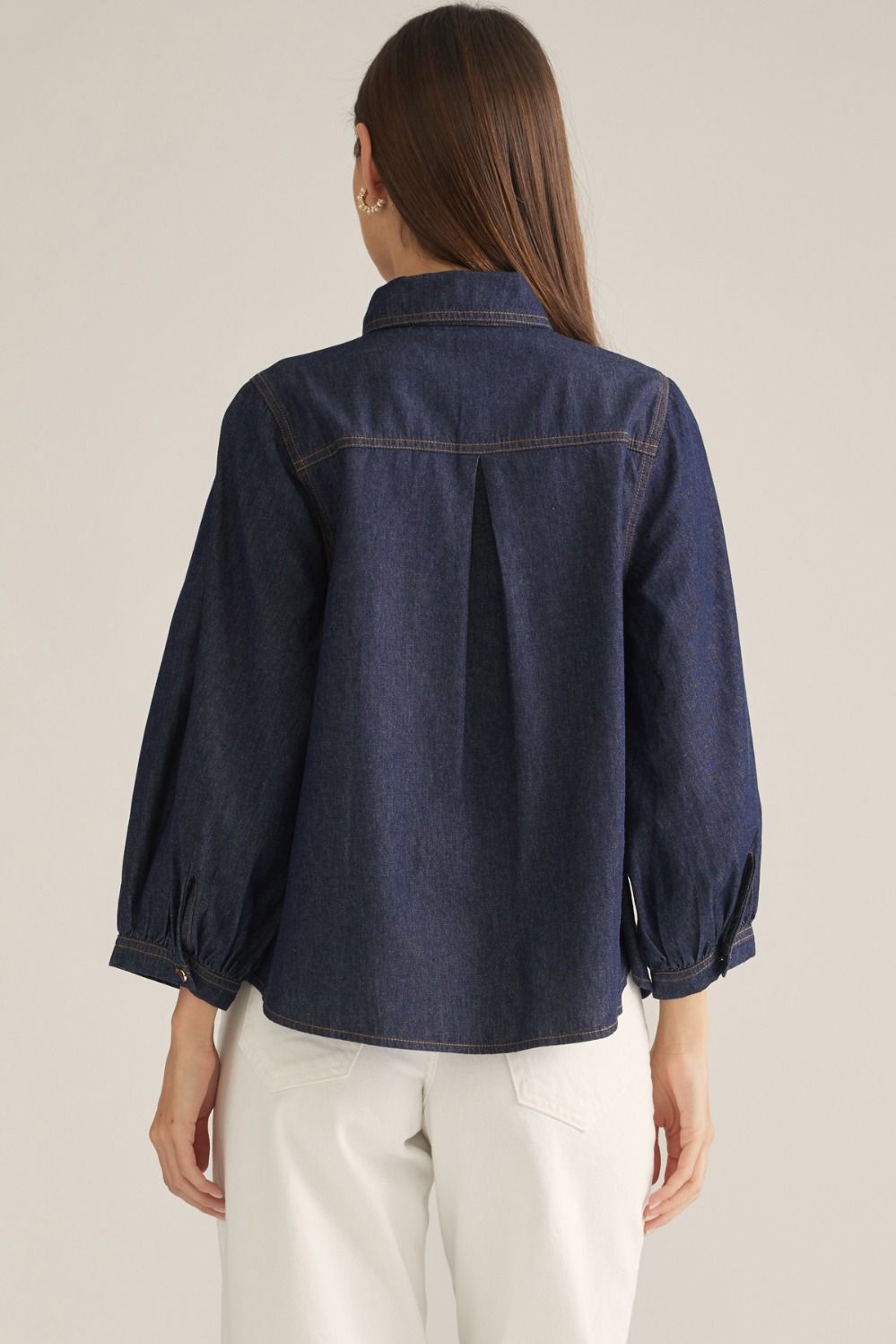 Women's denim-inspired woven top with high neckline, necktie detail, three-quarter puff sleeves, button front, and back pleats