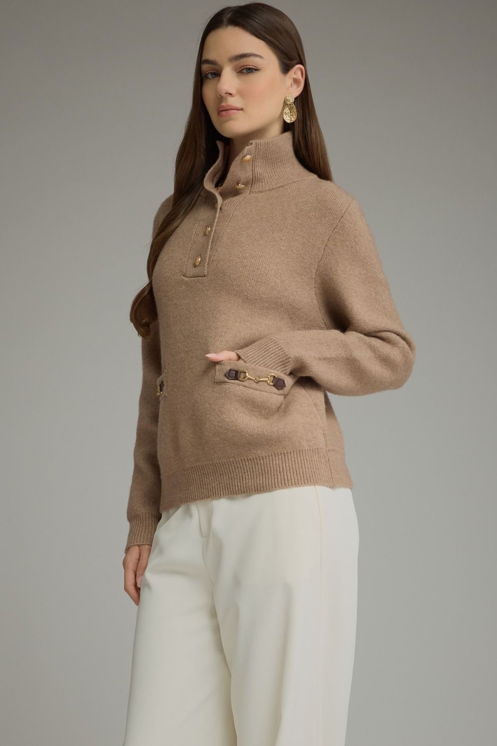 Solid long sleeve knit sweater top with stand neckline, button-front closure, and front pockets featuring buckle trim