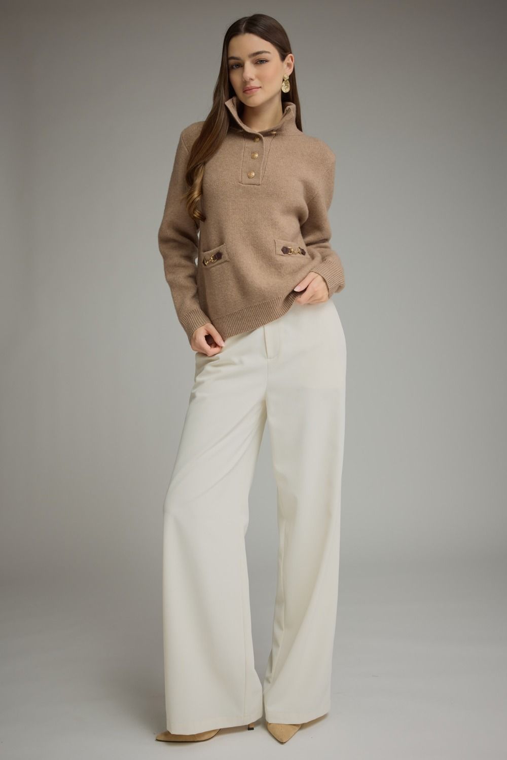 Solid long sleeve knit sweater top with stand neckline, button-front closure, and front pockets featuring buckle trim