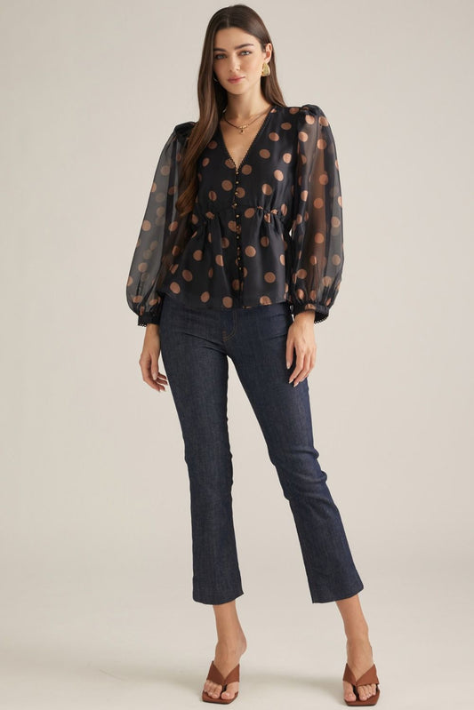 Women's polka dot woven top with V-neckline, long puff sleeves, decorative trim, button front, and elasticized back waist