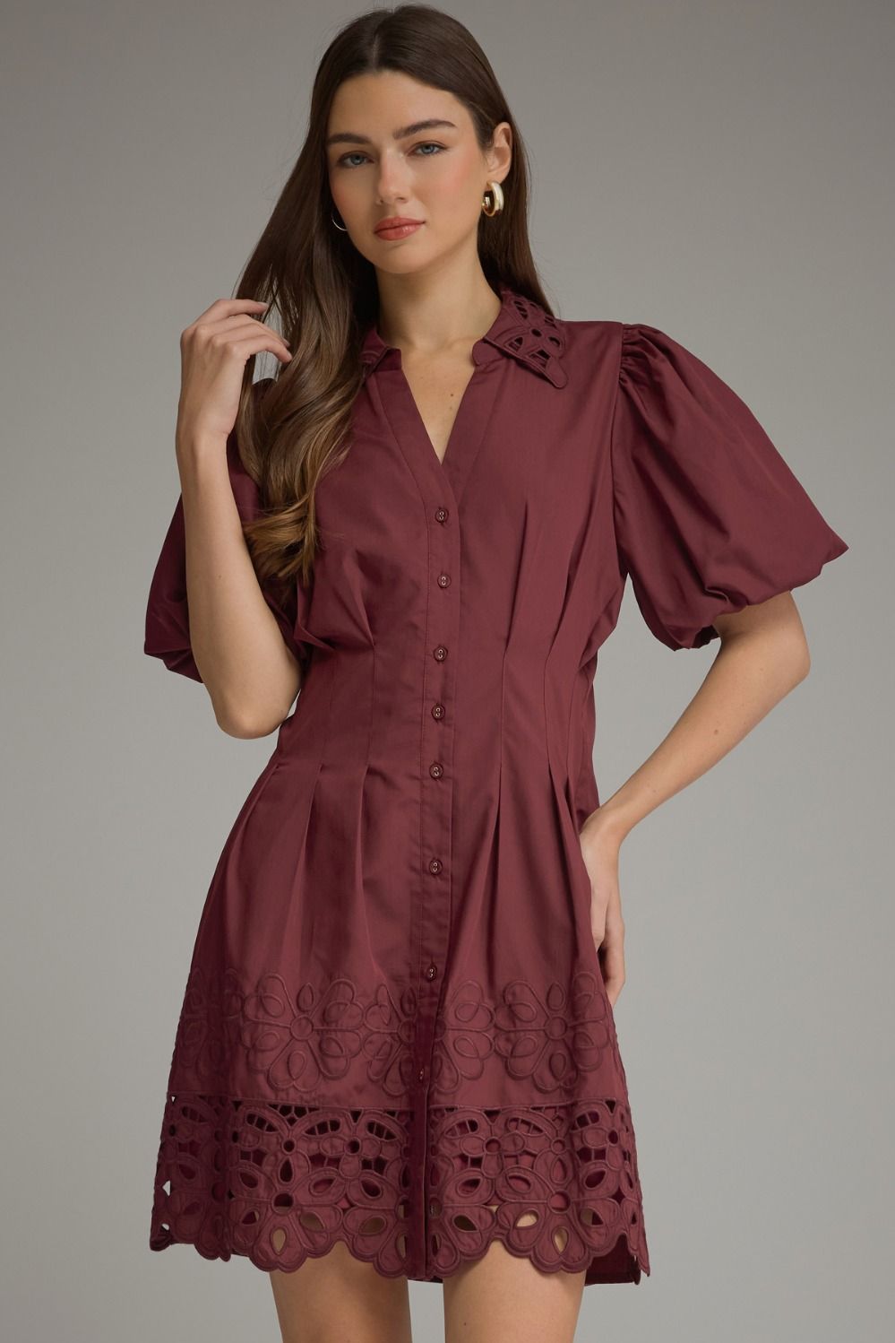 The Winifred Eyelet Collar Mini Dress combines romantic puff sleeves, delicate eyelet details, and a flattering pleated waist for effortlessly feminine style.