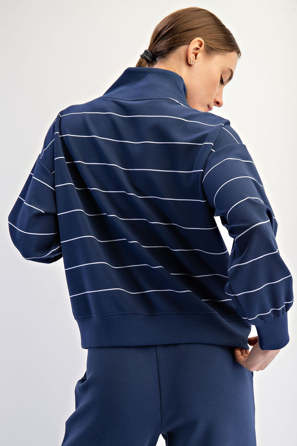 A silky-soft striped pullover with a mock neck, quarter zip, and kangaroo pocket for effortless comfort and style.