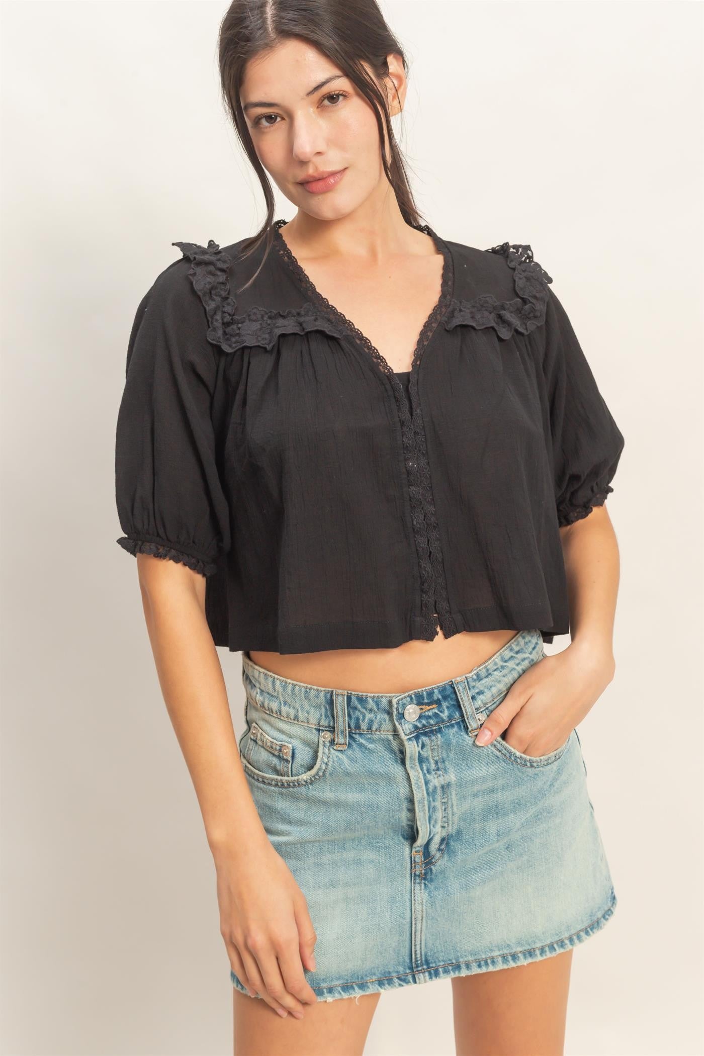  Lace Trim V-Neck Top features delicate ruffled lace accents and a relaxed silhouette 