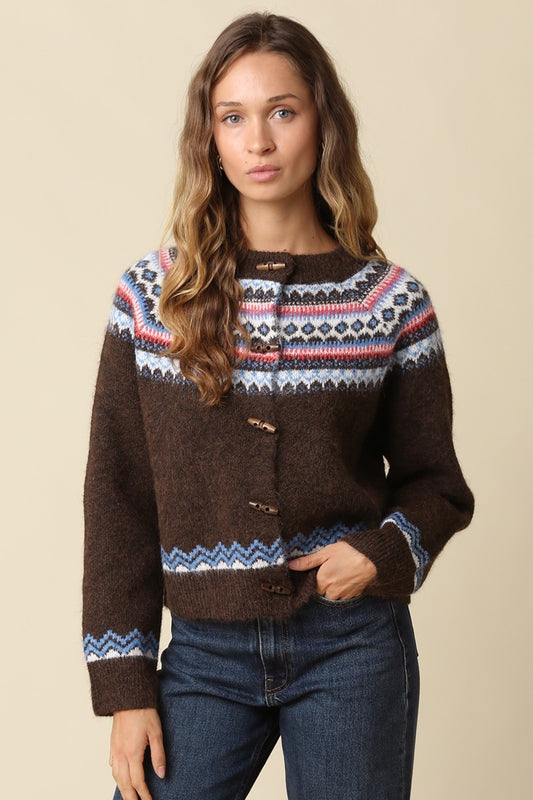 A cozy wool-blend knit cardigan featuring a classic Fair Isle pattern, charming toggle closures, and timeless Nordic-inspired style for chilly days.

