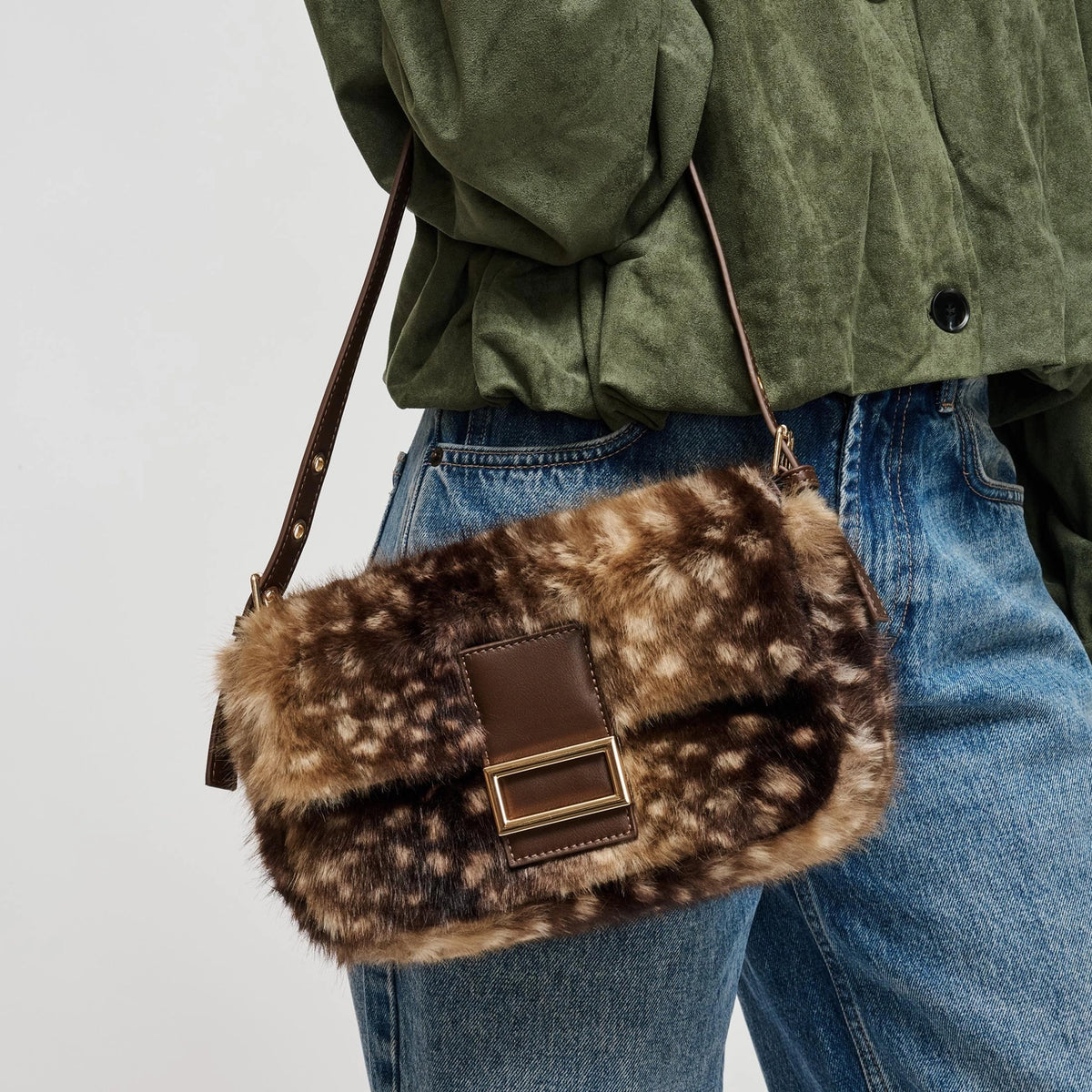 A luxe-looking faux fur crossbody bag featuring a polished rectangular buckle, adjustable strap, and practical interior storage for effortless day-to-night style.
