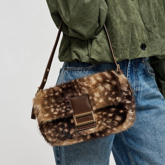 A luxe-looking faux fur crossbody bag featuring a polished rectangular buckle, adjustable strap, and practical interior storage for effortless day-to-night style.