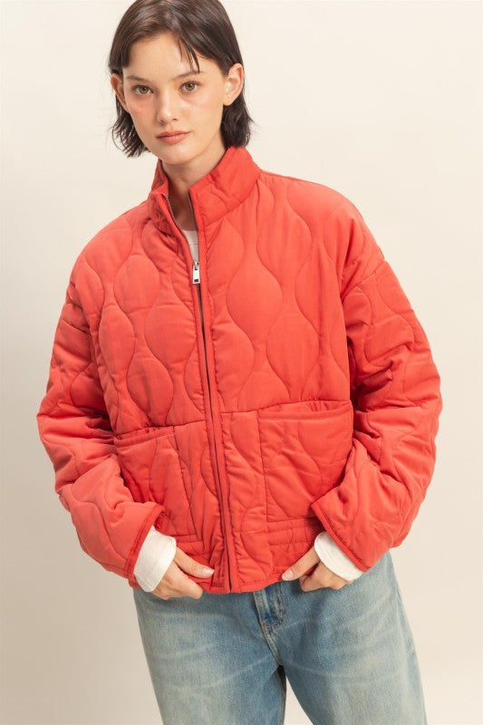 The Evadne Quilted Drawstring Jacket delivers cozy structure with a modern relaxed fit.