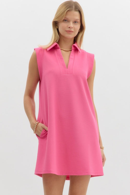 featuring a textured knit fabric, a sharp collared V-neckline, and side pockets for everyday practicality.