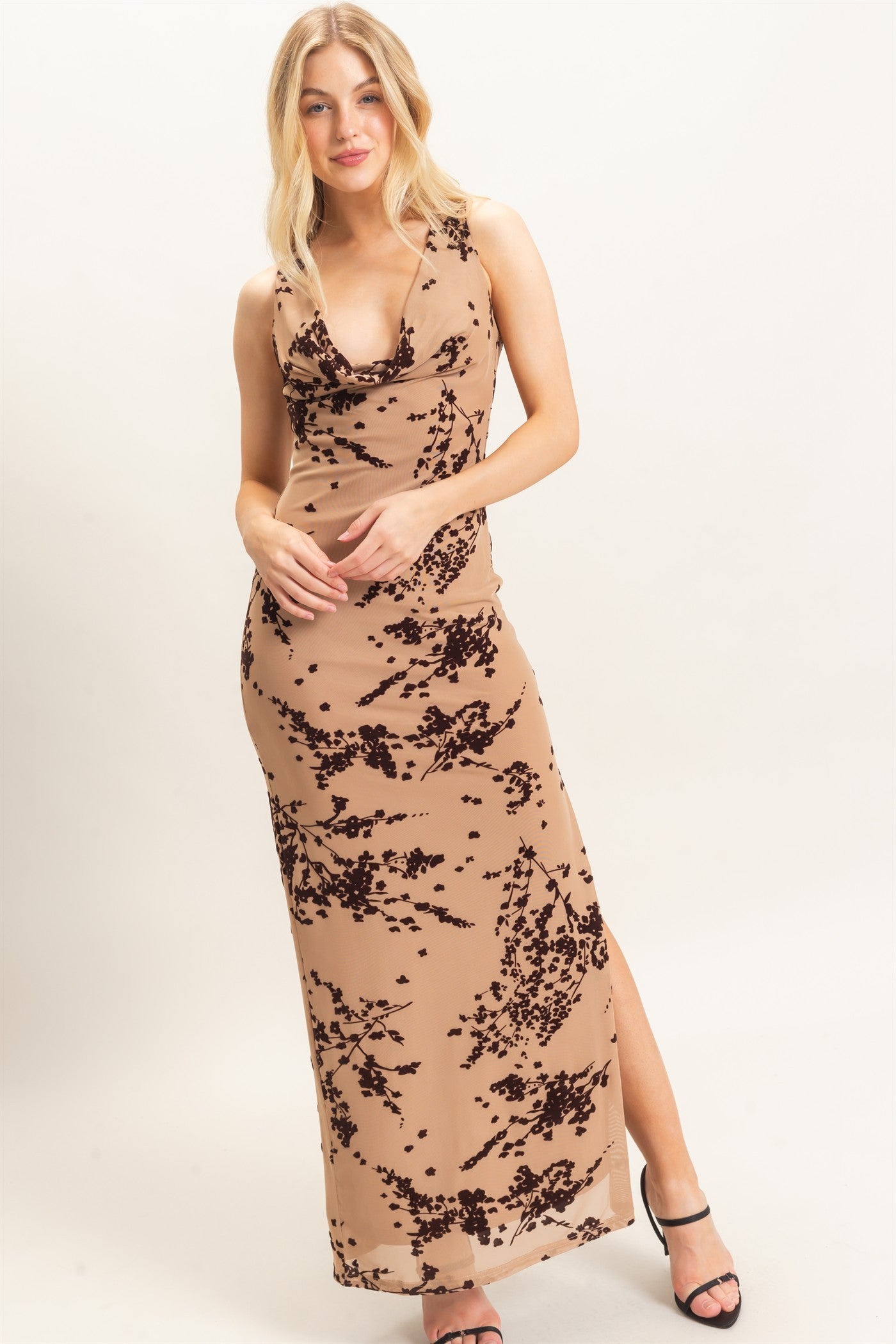 A sophisticated sleeveless dress featuring an elegant draped cowl neckline and subtle floral flocking for an effortlessly chic finish.
