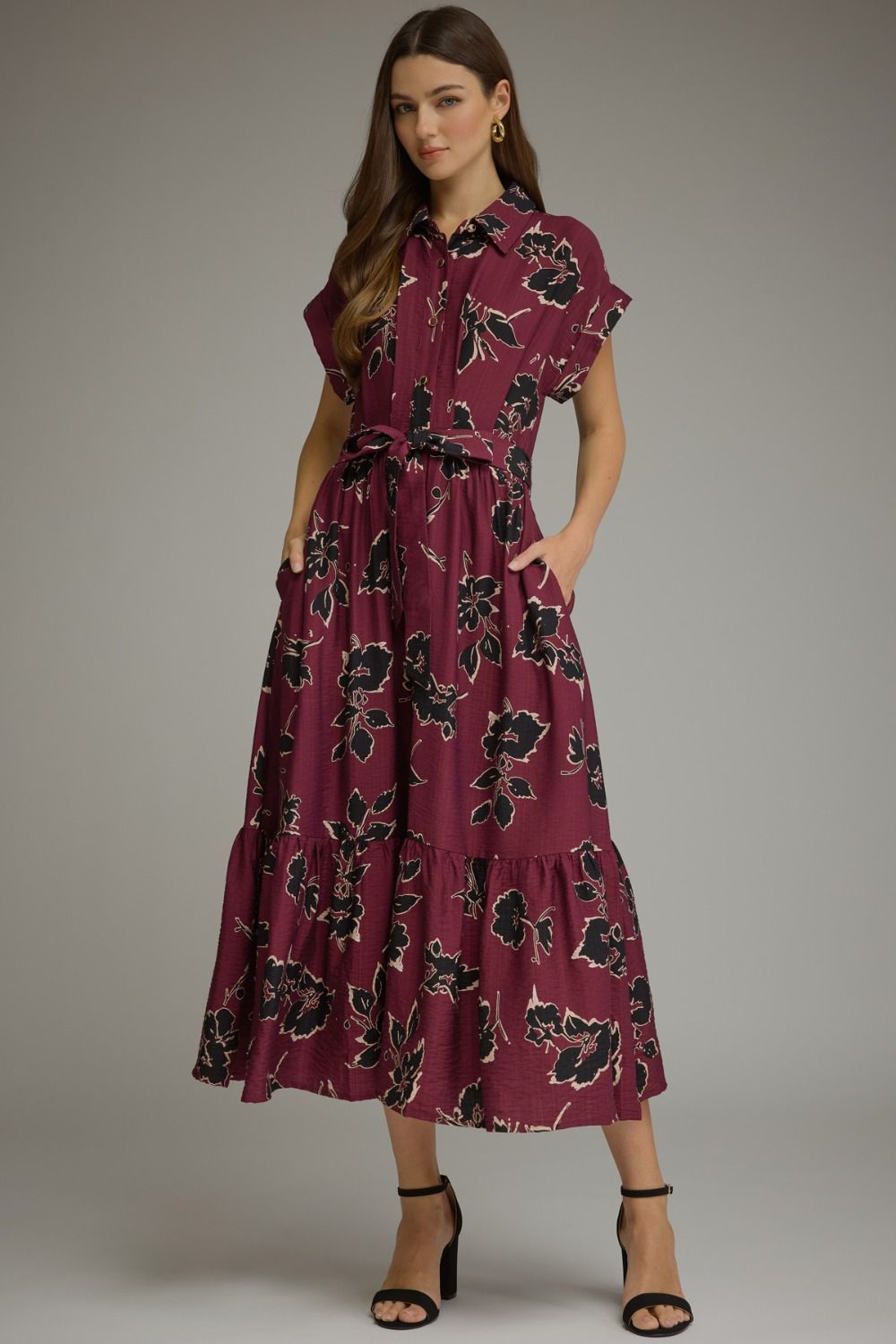 A feminine floral midi dress featuring a button-front bodice, adjustable self-tie waist, and flowing silhouette for timeless everyday elegance.