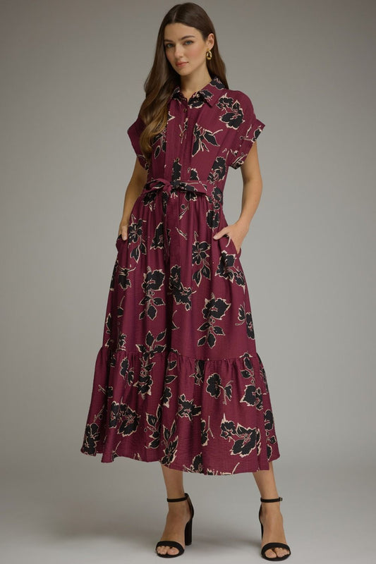 A feminine floral midi dress featuring a button-front bodice, adjustable self-tie waist, and flowing silhouette for timeless everyday elegance.