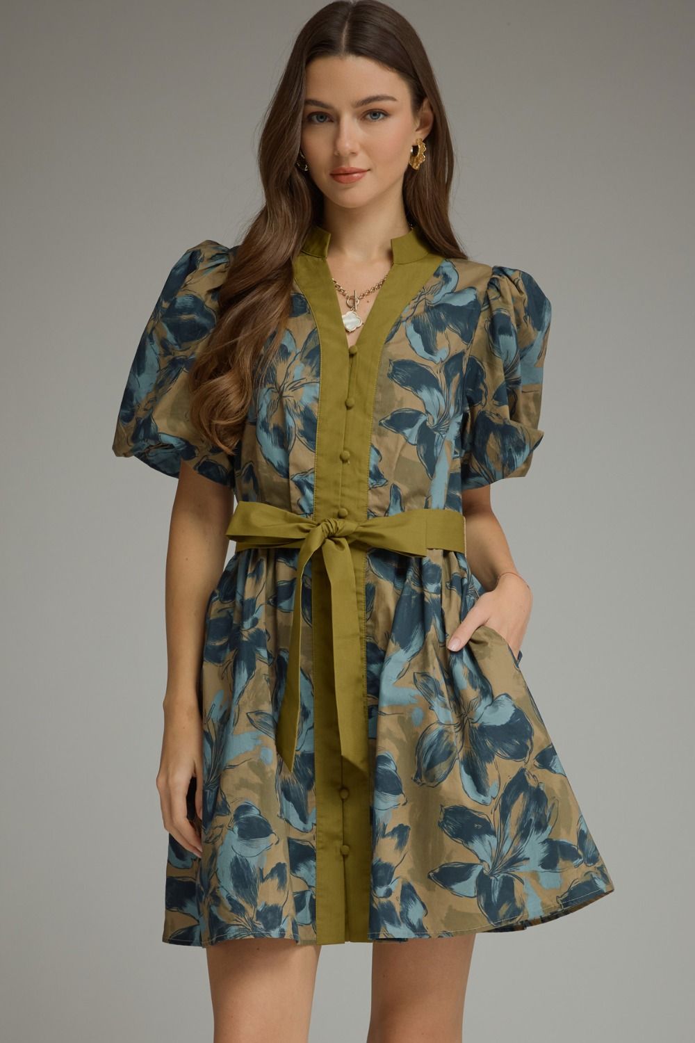 A charming floral mini dress featuring puff sleeves, a button-front design, and a self-tie waist for effortless feminine style.