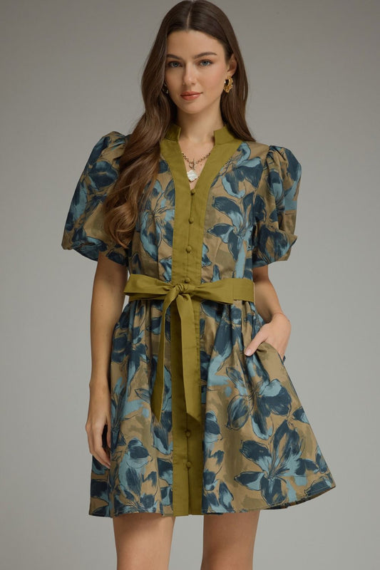A charming floral mini dress featuring puff sleeves, a button-front design, and a self-tie waist for effortless feminine style.