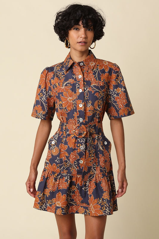 The Adele Floral Belted Mini Dress brings vintage-inspired charm to your wardrobe with a feminine fit-and-flare silhouette, button-front design, and playful tiered ruffle hem.