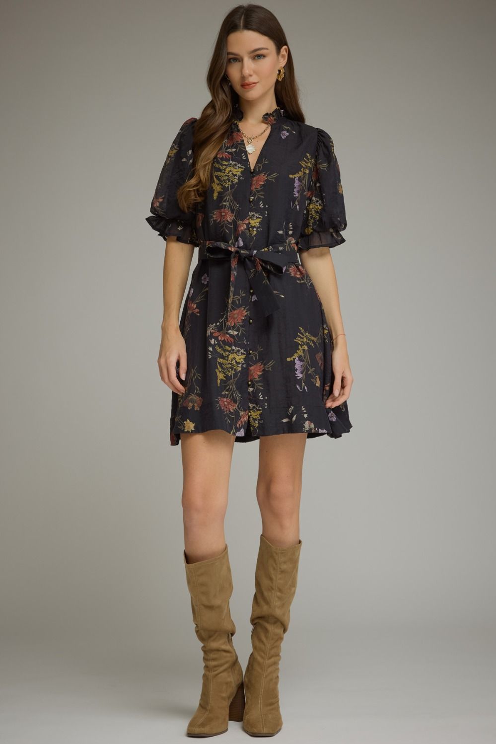 A romantic floral mini dress featuring puff sleeves, a self-tie waist belt, and a ruffled V-neckline for effortlessly feminine style.
