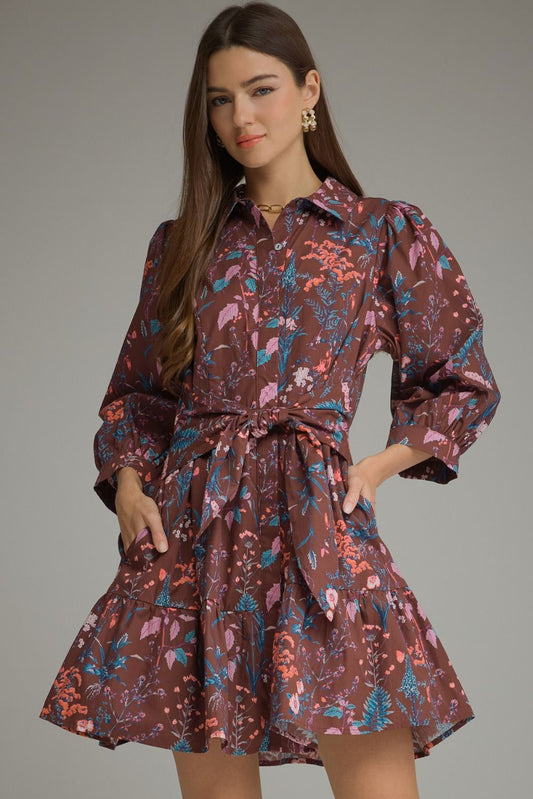 A charming floral mini dress featuring ¾ balloon sleeves, a classic shirt collar, self-tie waist, and playful tiered hem.
