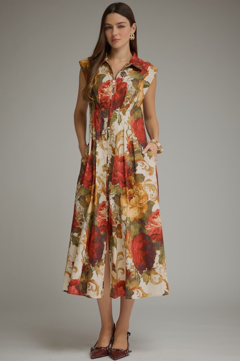 A feminine floral midi dress featuring a flattering foldover neckline, convenient front zipper, and effortless everyday elegance.