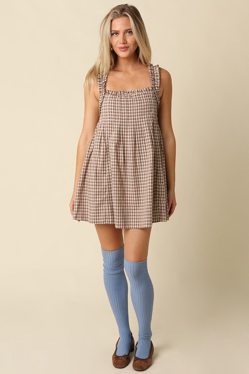 A sweet gingham babydoll mini dress featuring a flowy silhouette, ruffled shoulder straps, and lightweight cotton comfort for effortless warm-weather style.