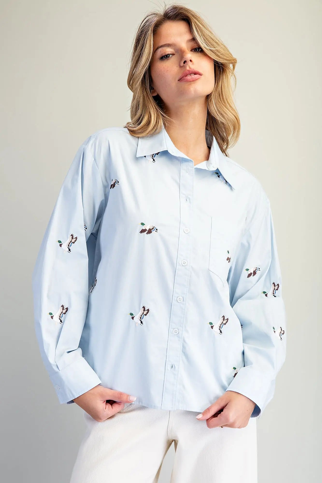 A timeless button-down shirt featuring charming embroidered mallard ducks, crisp tailoring, and an effortlessly polished silhouette.