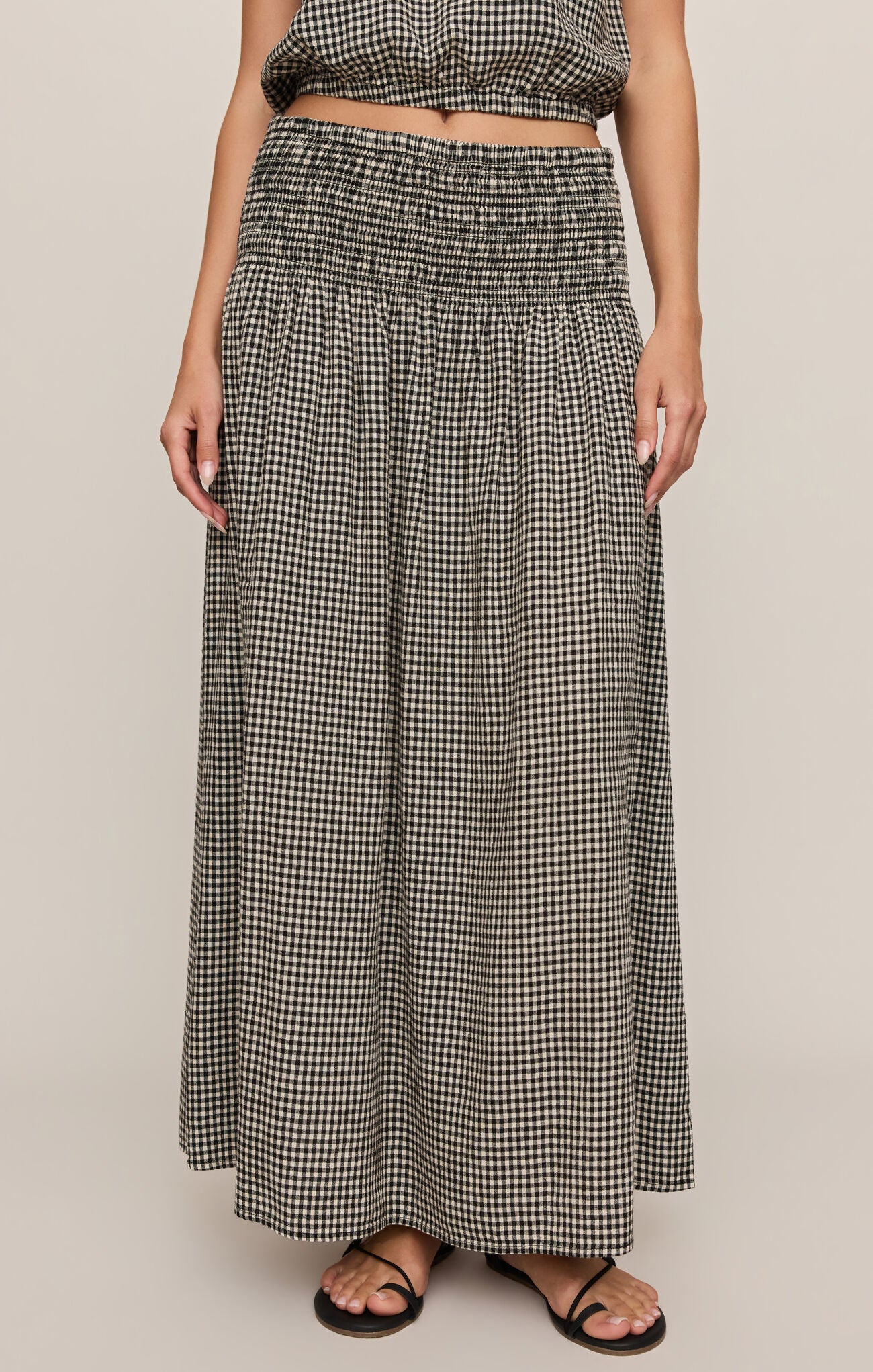 A breezy plaid linen-blend maxi skirt featuring a flattering smocked waistband and flowing silhouette for effortless, everyday elegance.
