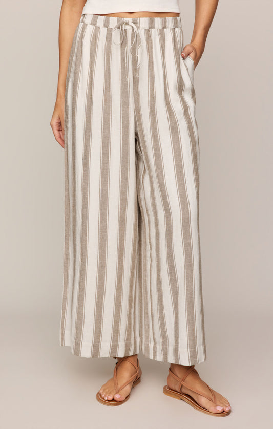 Effortlessly chic and breathable, these striped linen-blend pants feature a high-rise fit, adjustable drawcord waist, and relaxed ankle-length silhouette.