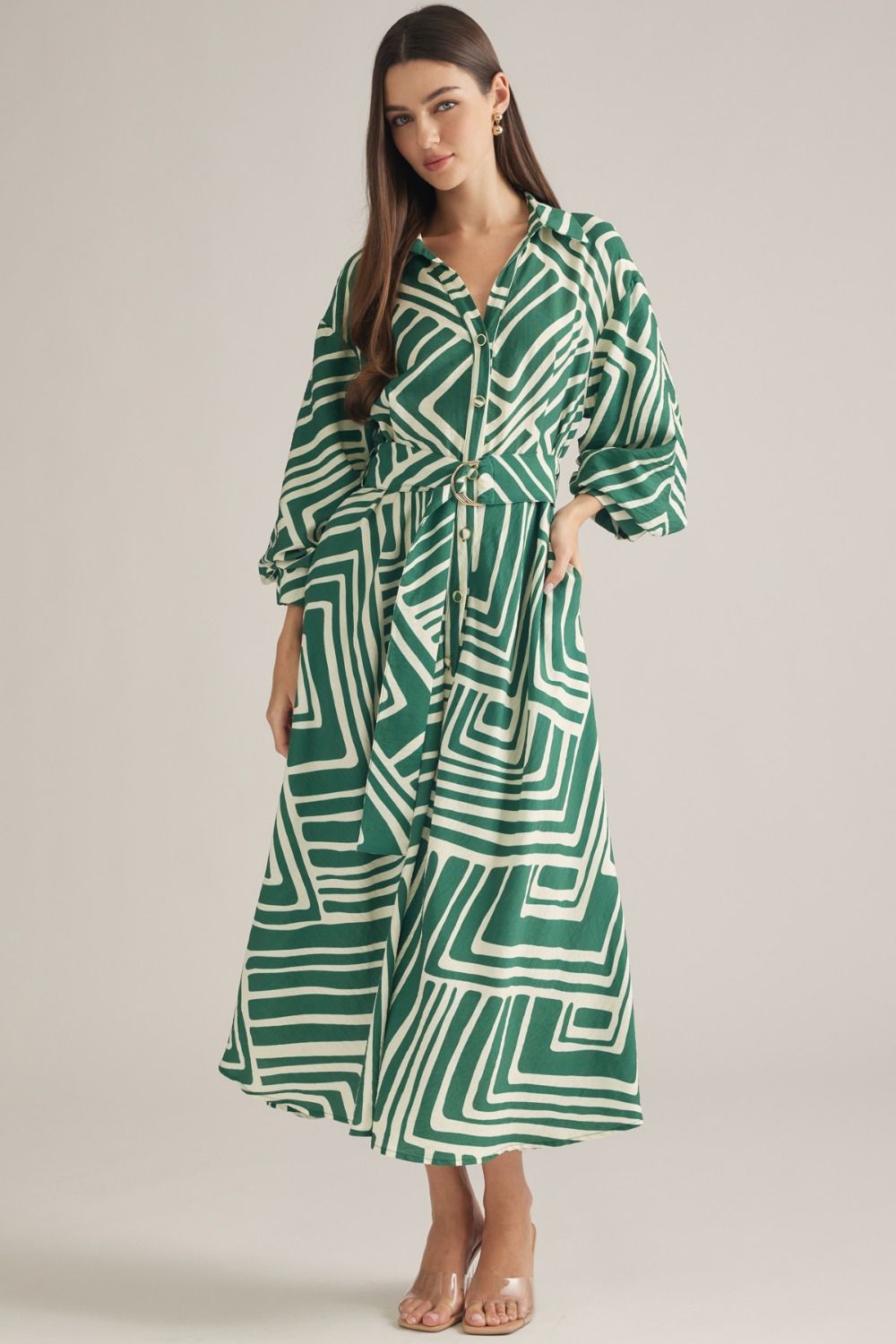 A sophisticated geometric print midi dress featuring balloon sleeves, a removable belt, and a flattering button-front silhouette.
