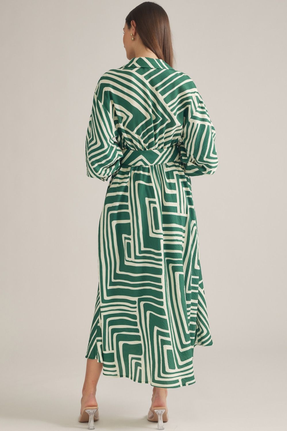 A sophisticated geometric print midi dress featuring balloon sleeves, a removable belt, and a flattering button-front silhouette.
