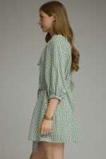A timeless gingham mini dress featuring ¾ sleeves, a self-tie waist belt, and a button-front design for effortlessly polished style.
