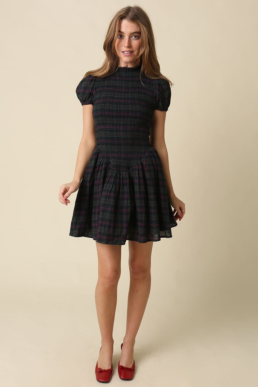 A timeless plaid mini dress featuring a flattering smocked bodice, feminine cap sleeves, and a softly gathered fit-and-flare skirt in breathable cotton.