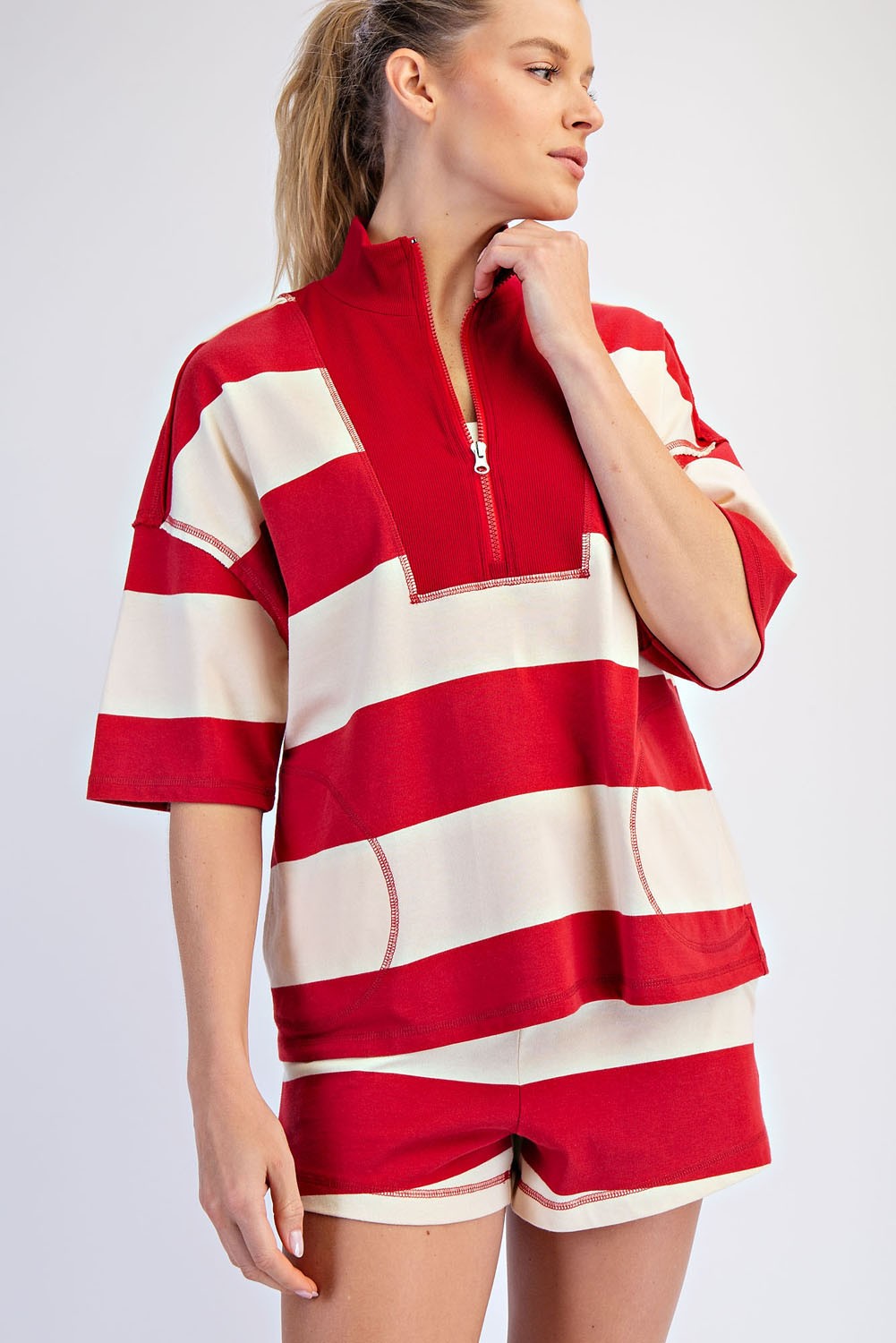 A lightweight striped cotton top with a sporty quarter-zip neckline, relaxed oversized fit, and effortlessly cool raw-edge details.