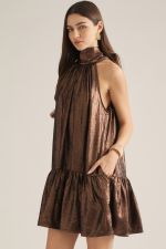 A flirty and feminine sleeveless mini dress featuring a halter neckline, back self-tie detail, and playful ruffle hem.