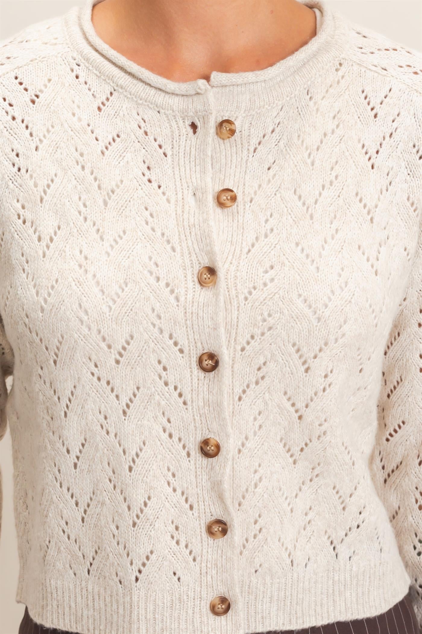 A timeless layering essential, this pointelle knit cardigan features a slightly cropped silhouette, button-front styling, and delicate details for effortless everyday charm.