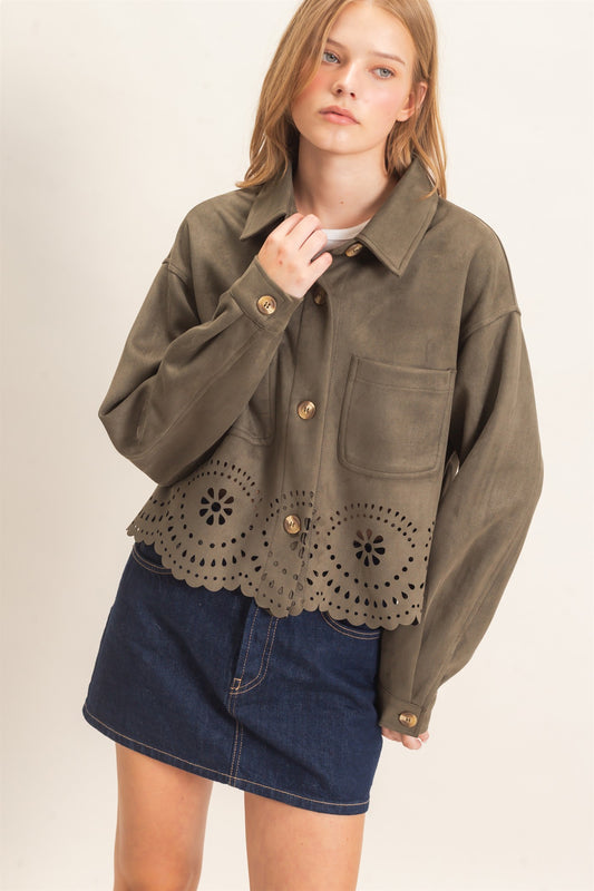A beautifully structured suede jacket with button-front styling, chest pockets, relaxed drop shoulders, and an intricate laser-cut floral hem.