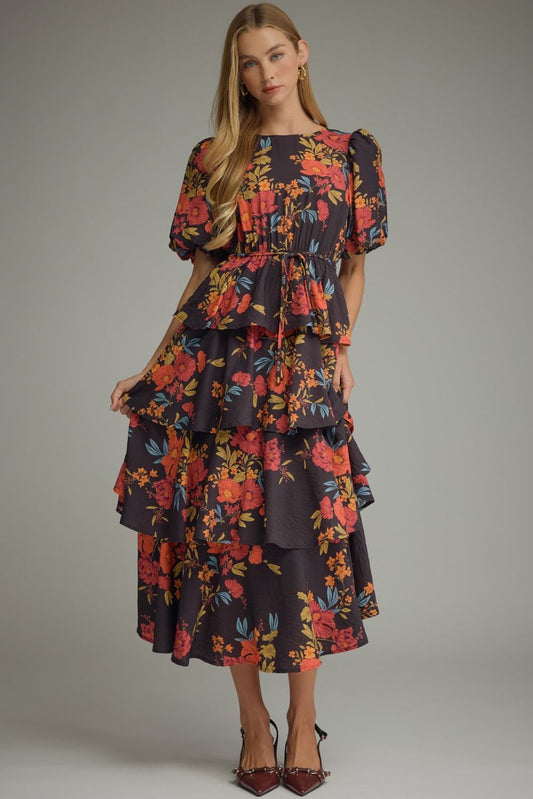 A feminine floral midi dress featuring charming puff sleeves, a flattering drawstring waist, and an effortlessly flowing tiered silhouette.