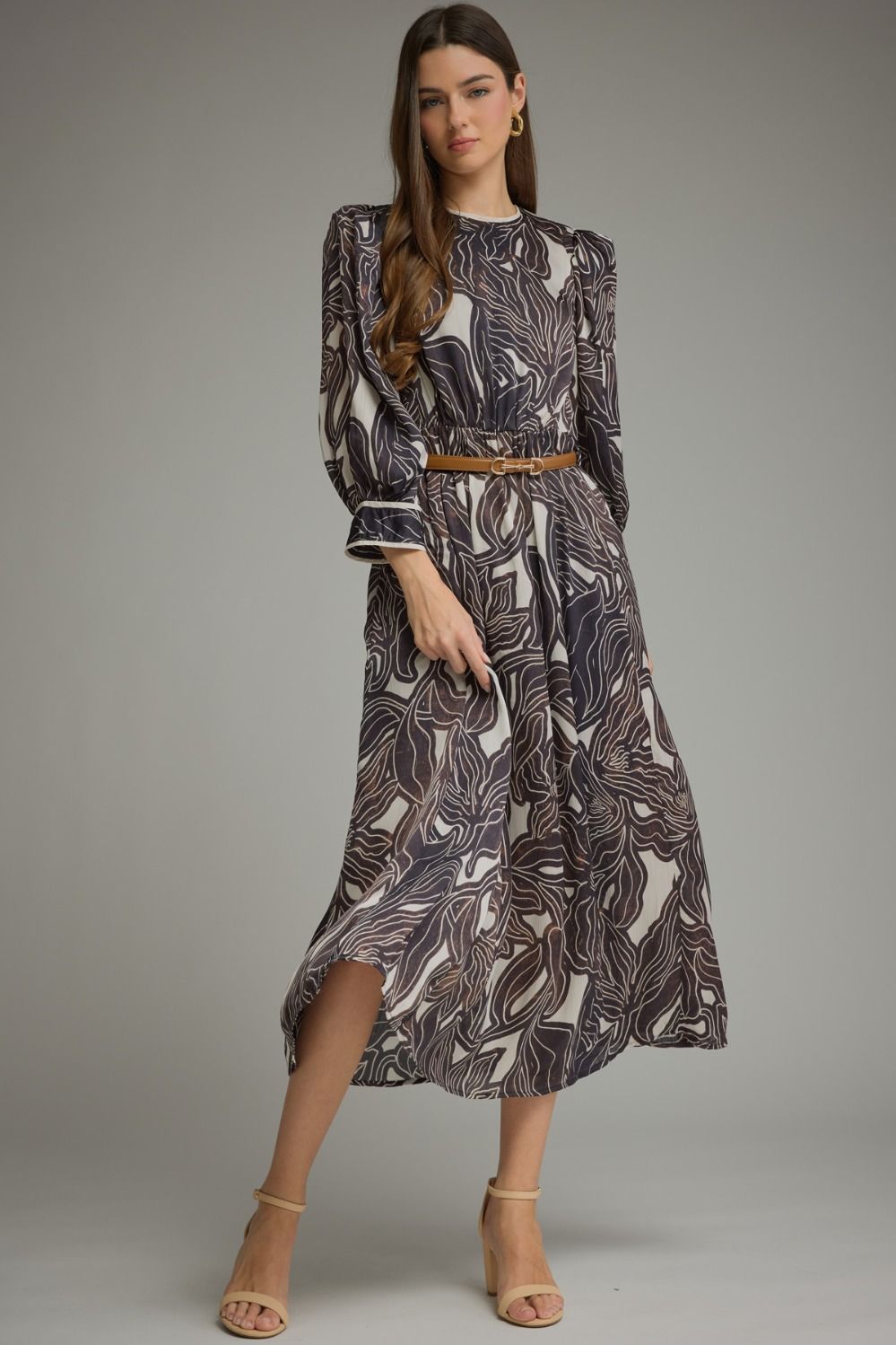A feminine leaf print midi dress featuring a flattering elastic waist, removable belt, contrast trim, and convenient side pockets.

