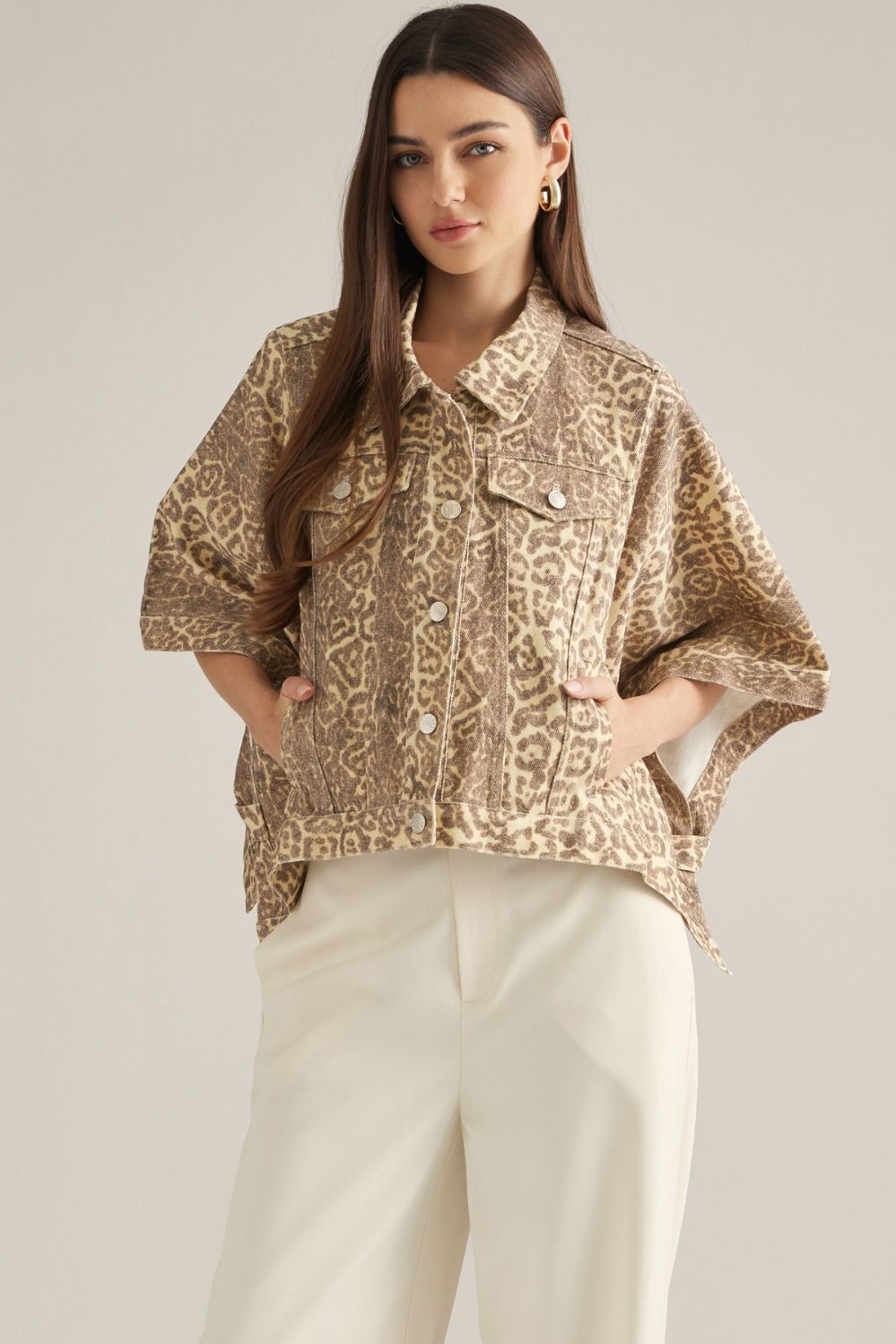 A statement-making animal print jacket featuring dramatic poncho sleeves, a button front, and convenient pockets in a soft cotton-blend fabric.

