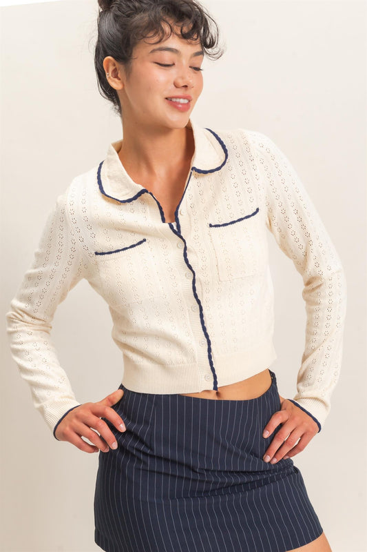 A refined pointelle knit cardigan featuring a classic point collar, contrast trim, and a timeless button-front design for effortless everyday elegance.
