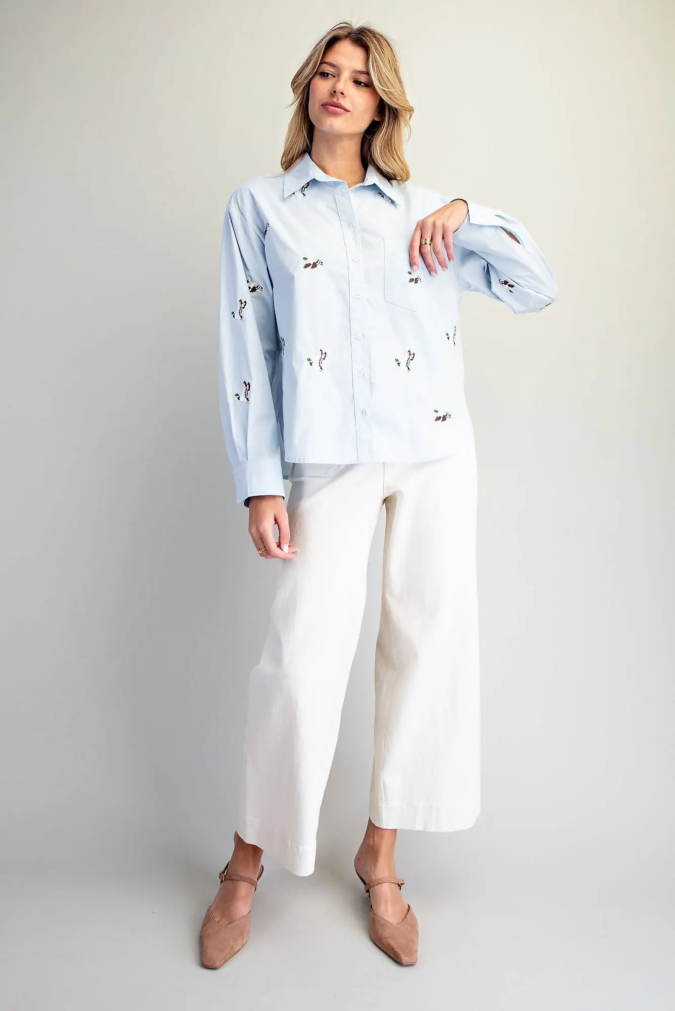 A timeless button-down shirt featuring charming embroidered mallard ducks, crisp tailoring, and an effortlessly polished silhouette.