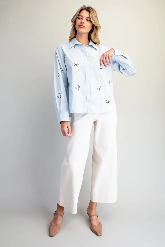 A timeless button-down shirt featuring charming embroidered mallard ducks, crisp tailoring, and an effortlessly polished silhouette.