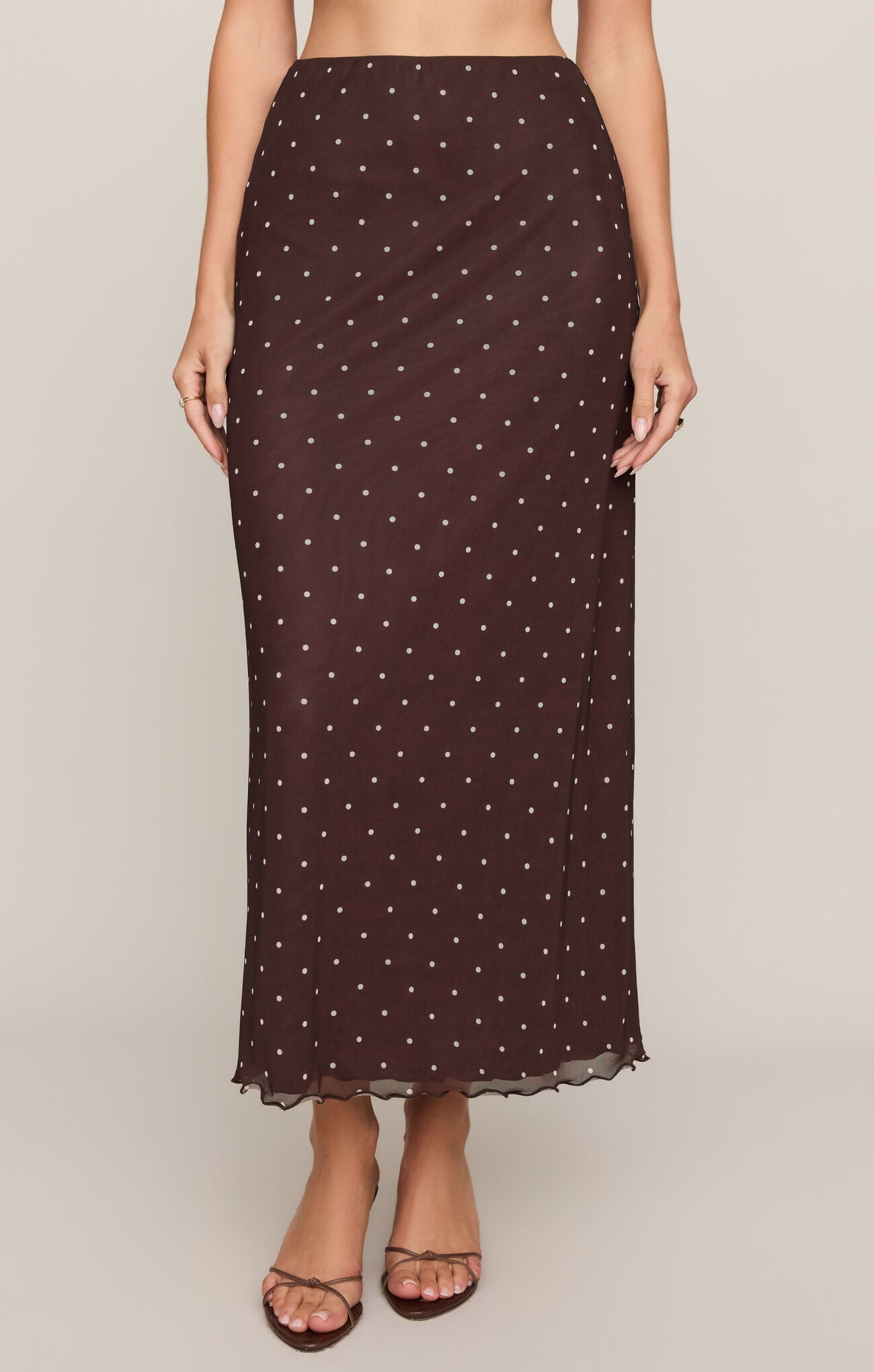 A chic mesh midi skirt featuring a high-rise elastic waistband, comfortable stretch fabric, and a lined silhouette for effortless feminine style.