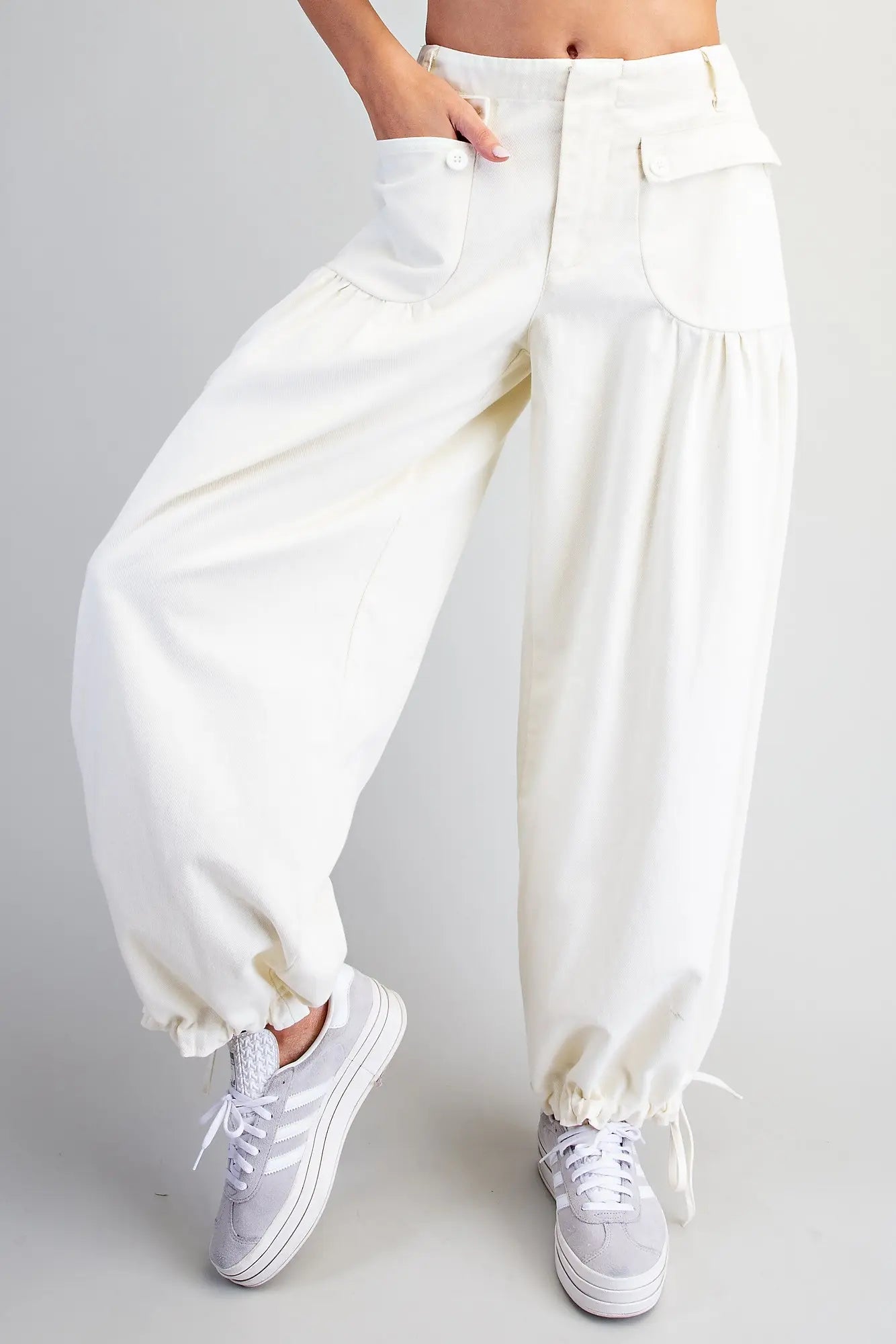 Relaxed mineral washed harem pants featuring adjustable tie cuffs, utility-inspired pockets, and a comfortable elastic back waistband for effortless everyday style.