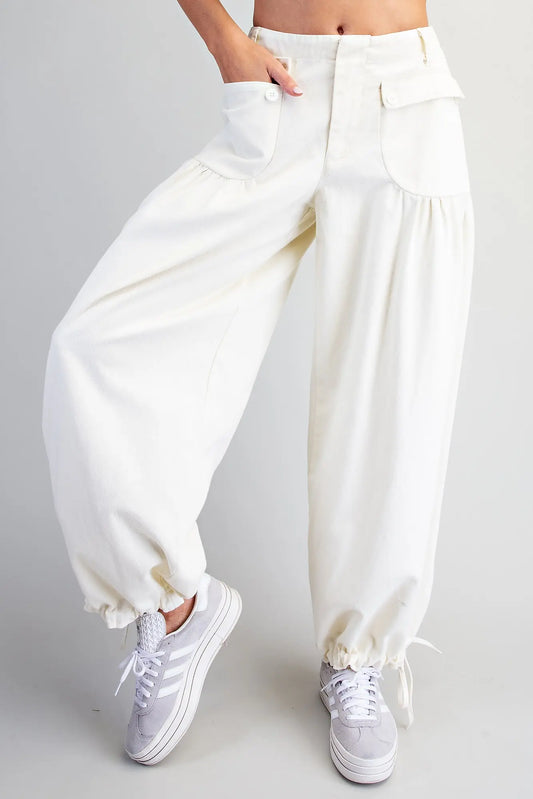 Relaxed mineral washed harem pants featuring adjustable tie cuffs, utility-inspired pockets, and a comfortable elastic back waistband for effortless everyday style.