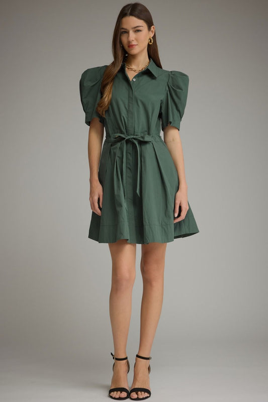 A feminine mini dress featuring playful puff sleeves, a classic shirt collar, waist tie detail, and a beautifully pleated skirt.

