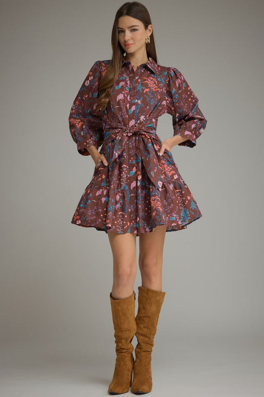 A charming floral mini dress featuring ¾ balloon sleeves, a classic shirt collar, self-tie waist, and playful tiered hem.
