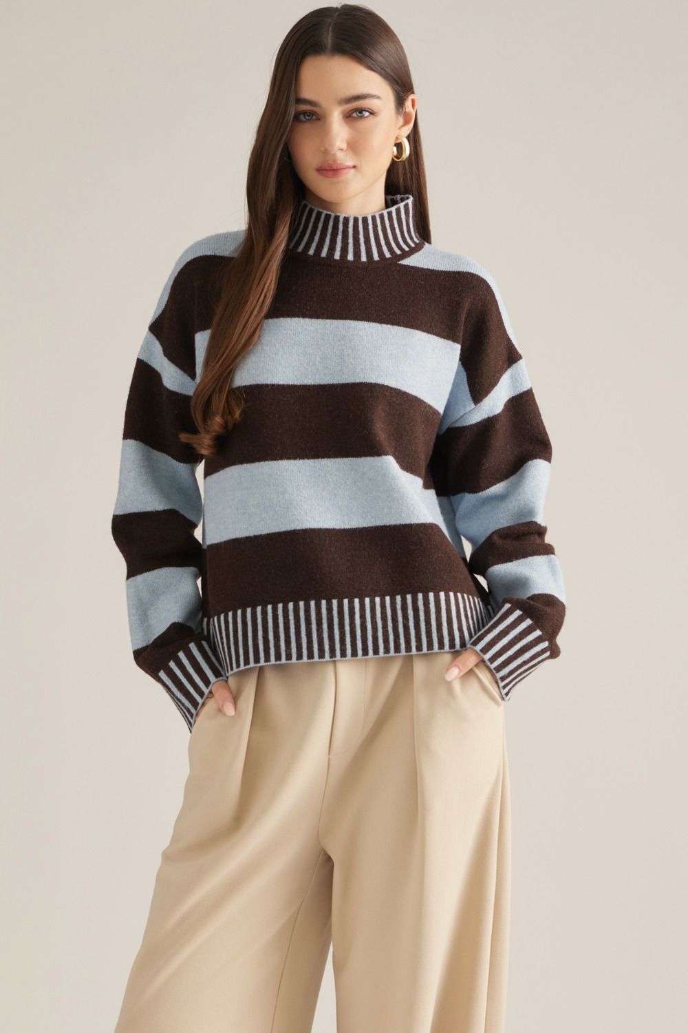 A cozy striped sweater featuring a classic mock neckline, long sleeves, and ribbed trim for an effortlessly polished cold-weather look.