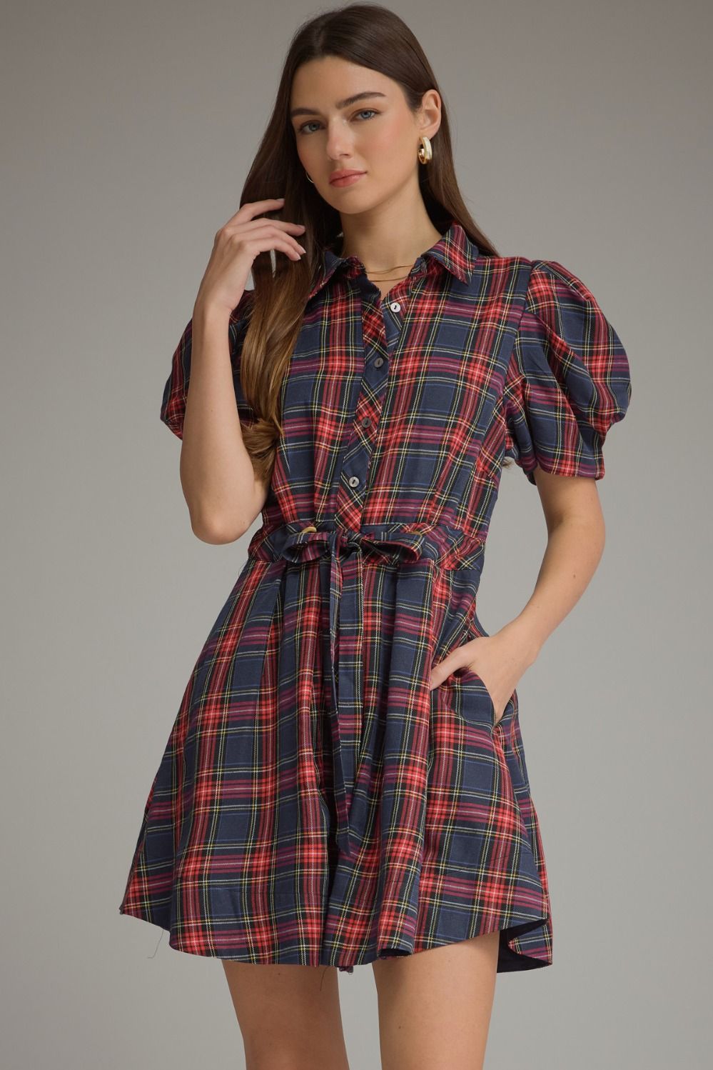 A charming plaid mini dress featuring feminine puff sleeves, a classic shirt collar, and a self-tie waist for a flattering silhouette.

