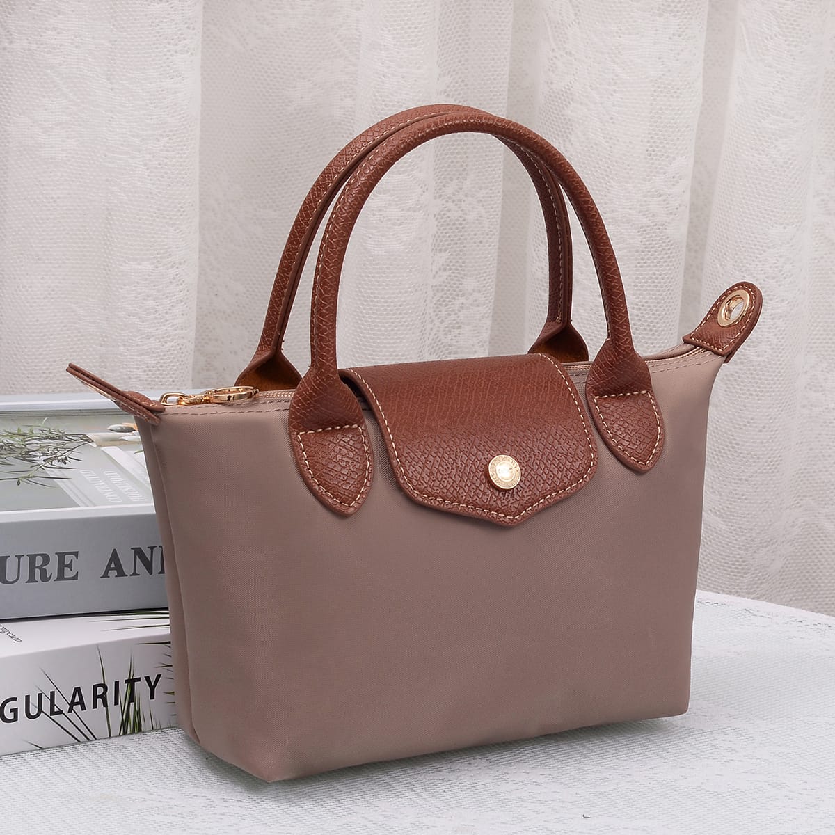 A lightweight, versatile nylon crossbody bag featuring double handles for easy carrying and effortless everyday style.

