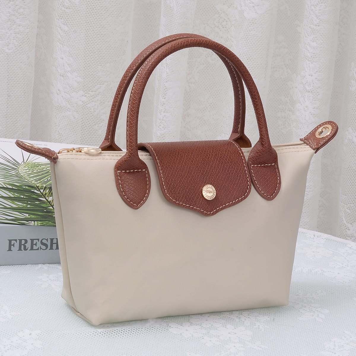 A lightweight, versatile nylon crossbody bag featuring double handles for easy carrying and effortless everyday style.

