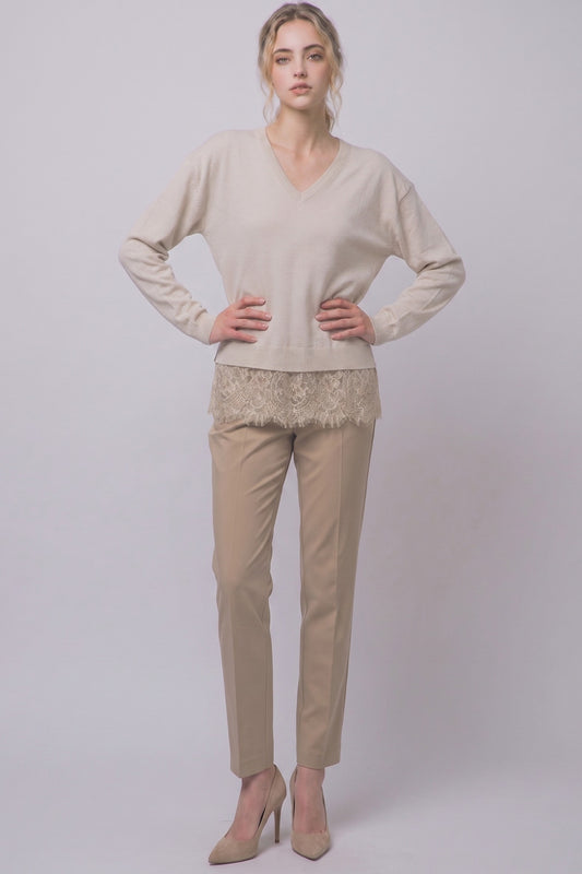 Cozy meets feminine in this oversized V-neck sweater, featuring long sleeves and a delicate lace-trim hem for a romantic, effortlessly chic look.